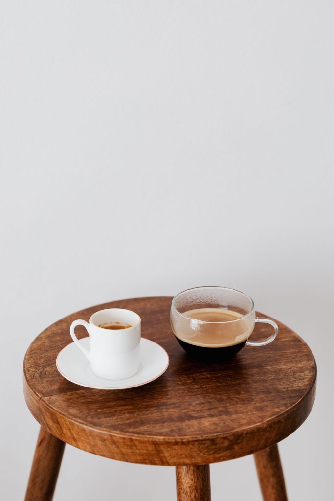Coffee in different cups on small table