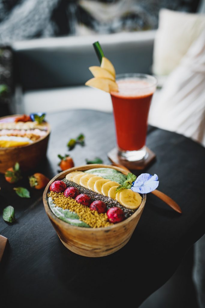 Delicious dessert with fruits and juice on table