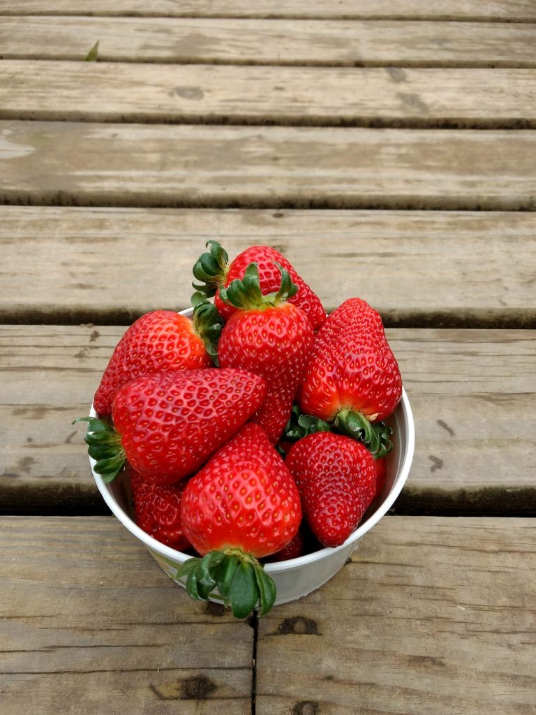 Fresh strawberry on wooden surface